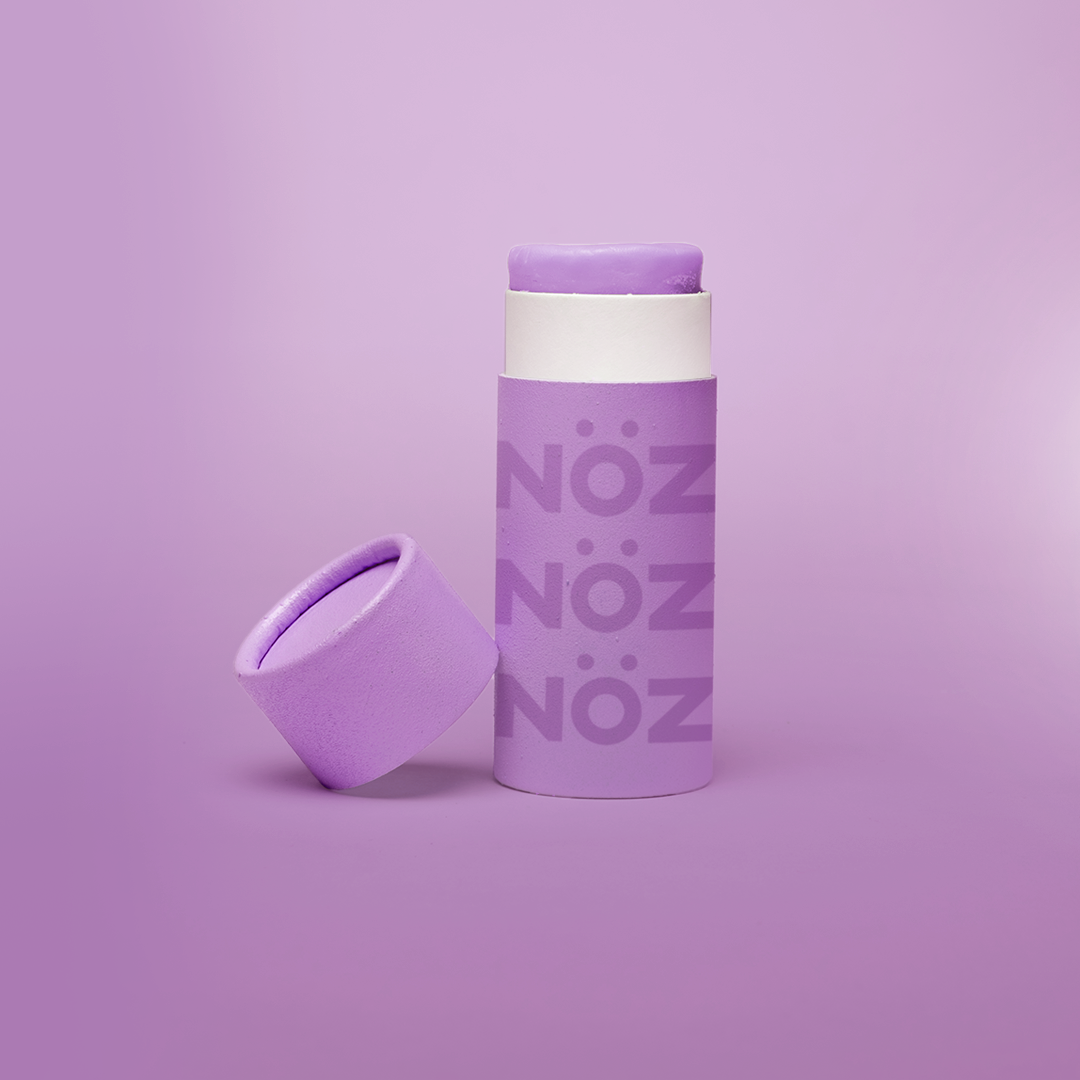 Purple colored Nözscreen bottle with removed cap against Purple gradient background. 